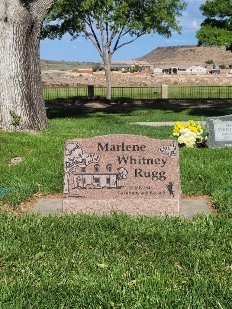 Custom engraved headstone for Marlene Whitney Rugg in a cemetery.